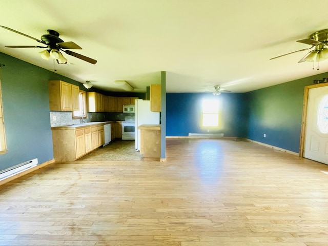 kitchen featuring white appliances, baseboards, a ceiling fan, open floor plan, and light wood-type flooring