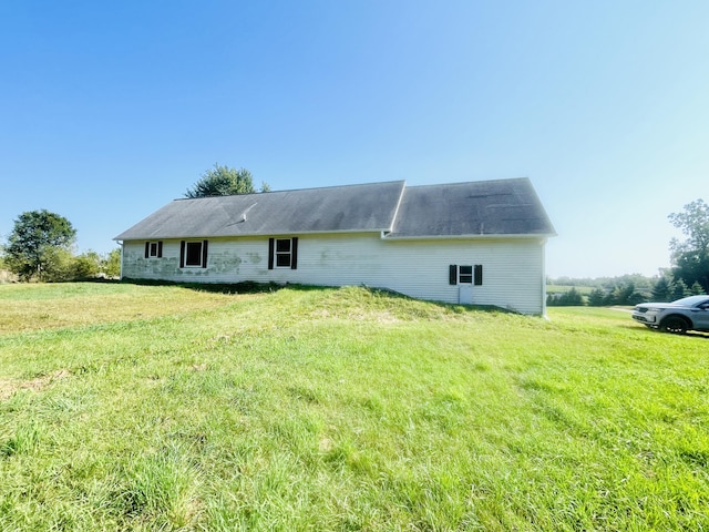 back of house featuring a yard