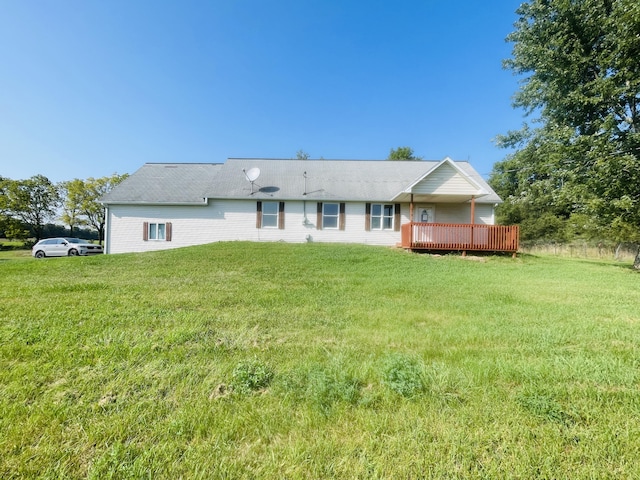 back of house featuring a yard and a wooden deck