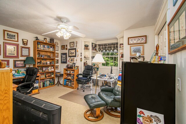 carpeted home office with a textured ceiling and ceiling fan