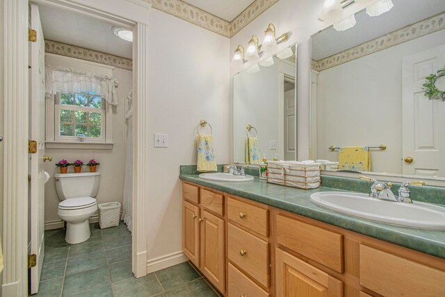 bathroom featuring tile patterned flooring, vanity, and toilet