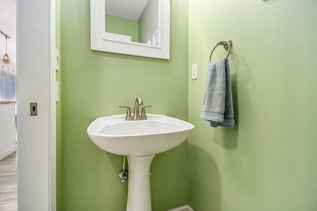 bathroom with hardwood / wood-style floors