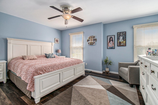 bedroom with ceiling fan and dark hardwood / wood-style flooring