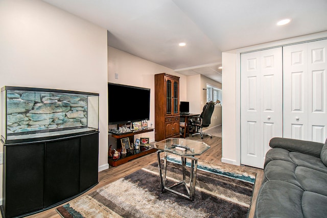 living room with lofted ceiling and hardwood / wood-style floors