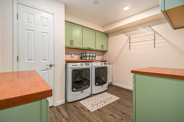 laundry room featuring separate washer and dryer, cabinets, and dark hardwood / wood-style floors