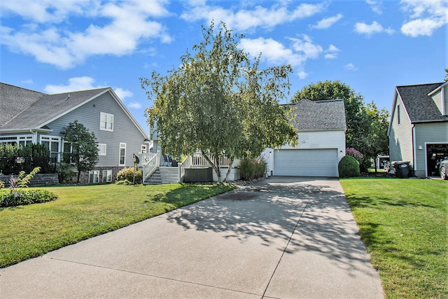 view of front of house featuring a garage and a front lawn