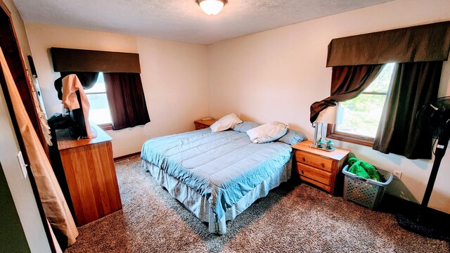 carpeted bedroom featuring a textured ceiling