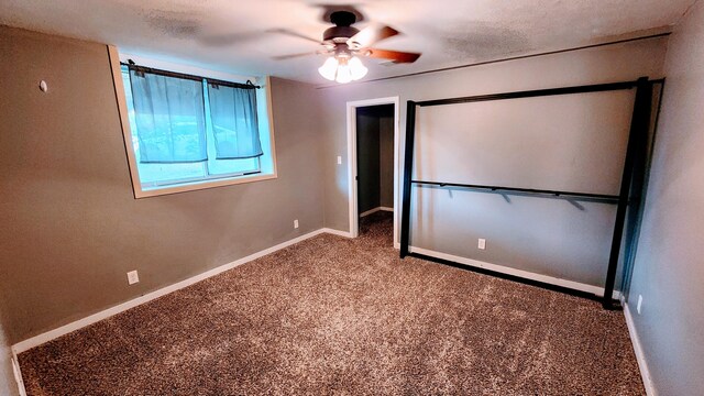 unfurnished bedroom featuring ceiling fan and carpet