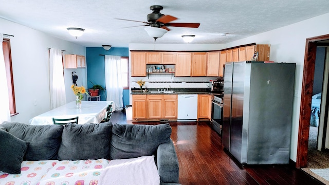 kitchen with dark hardwood / wood-style flooring, sink, ceiling fan, decorative backsplash, and appliances with stainless steel finishes