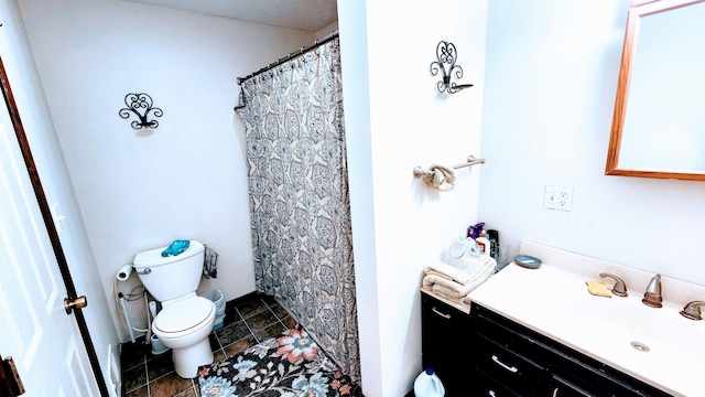 bathroom with vanity, toilet, walk in shower, and tile patterned floors