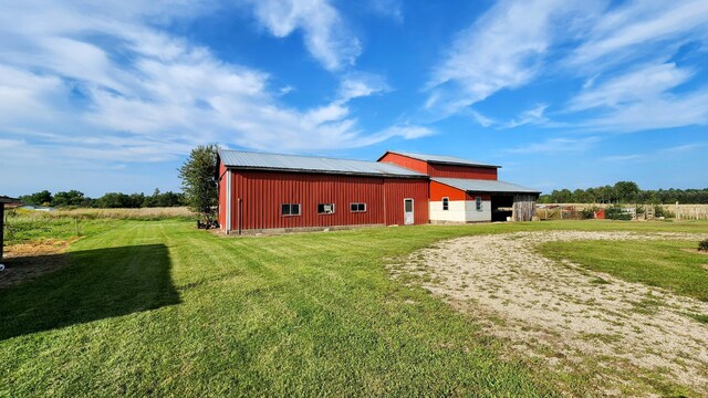 view of outdoor structure featuring a yard and a rural view