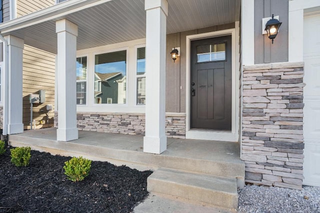 view of exterior entry featuring covered porch