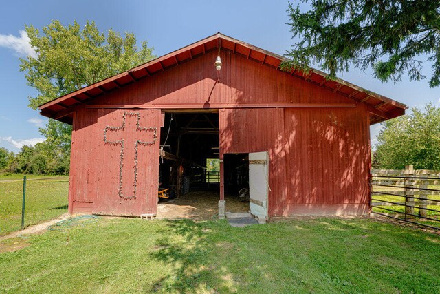 view of outbuilding featuring a lawn