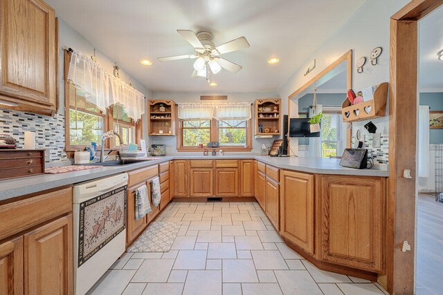 kitchen with ceiling fan, decorative backsplash, white dishwasher, sink, and light tile patterned flooring