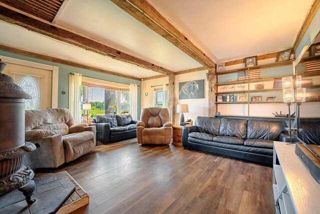 living room featuring beam ceiling and dark hardwood / wood-style flooring