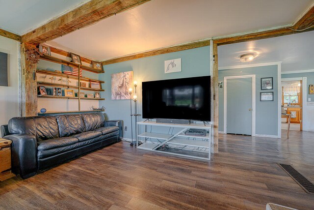 living room with crown molding and dark hardwood / wood-style floors