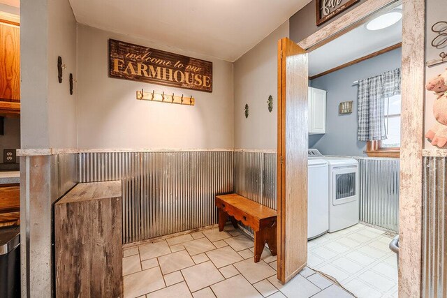 interior space with light tile patterned floors, washing machine and dryer, and cabinets