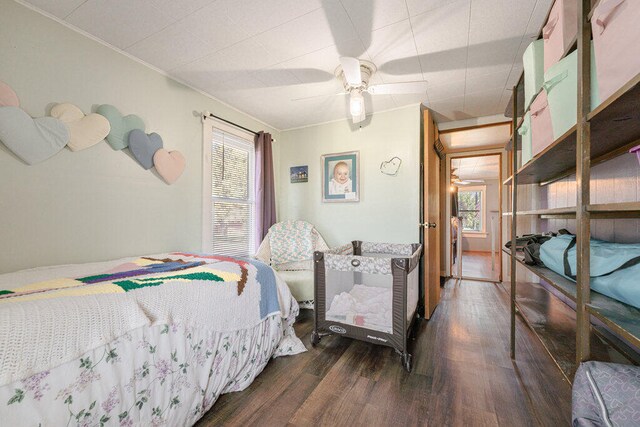 bedroom featuring ceiling fan, hardwood / wood-style floors, and ornamental molding