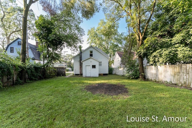 view of yard featuring an outdoor structure and a fenced backyard