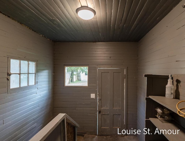 entrance foyer featuring wood walls and wood ceiling