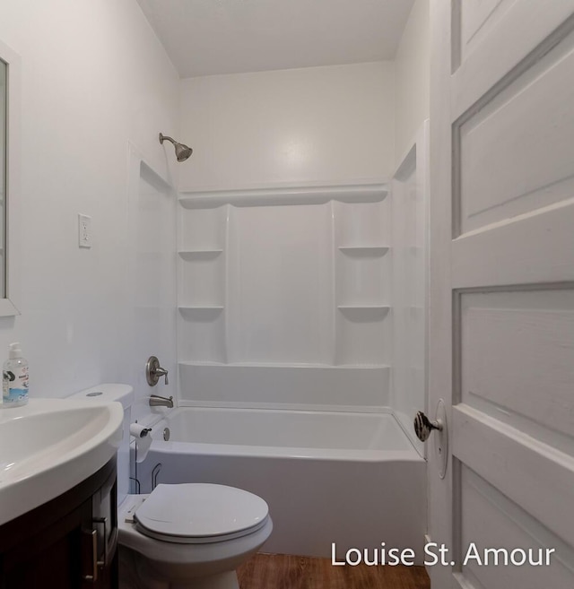 full bathroom featuring toilet, tub / shower combination, wood finished floors, and vanity