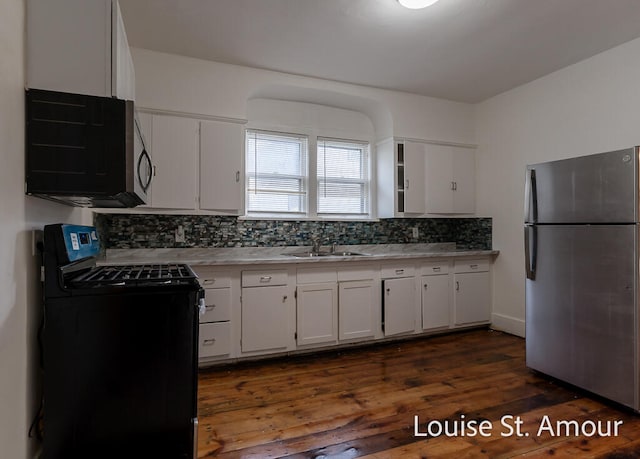 kitchen featuring stainless steel fridge, dark wood-type flooring, electric range, decorative backsplash, and white cabinetry