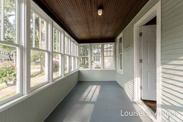 unfurnished sunroom with wood ceiling