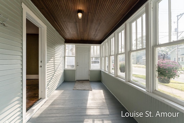 unfurnished sunroom featuring wood ceiling