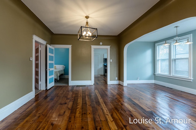 interior space with dark hardwood / wood-style floors and an inviting chandelier