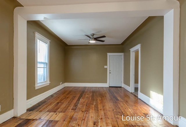 empty room with ceiling fan and light hardwood / wood-style floors