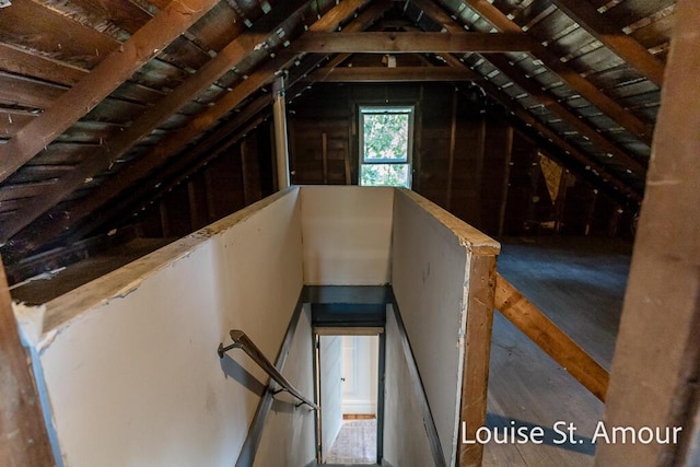 unfinished attic with an upstairs landing
