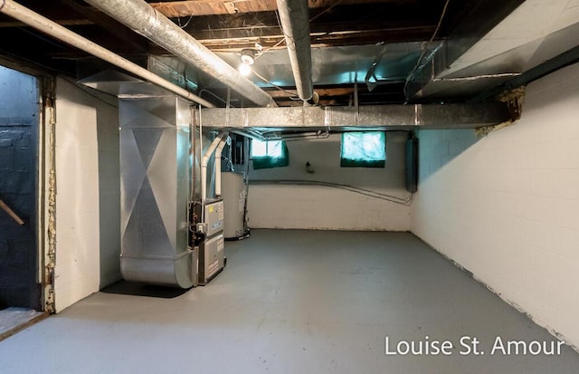 basement with water heater and heating unit