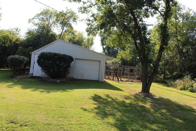 exterior space featuring a garage and an outbuilding