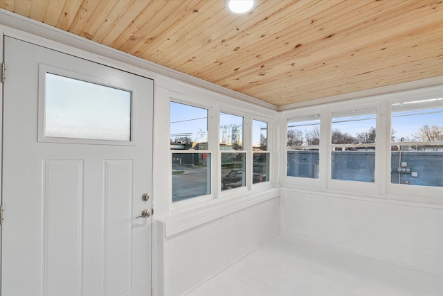 sunroom featuring a healthy amount of sunlight and wooden ceiling