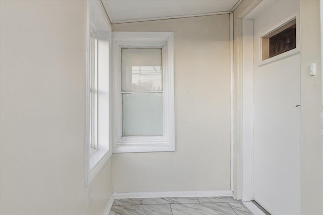 spare room featuring plenty of natural light, vaulted ceiling, and light tile patterned floors