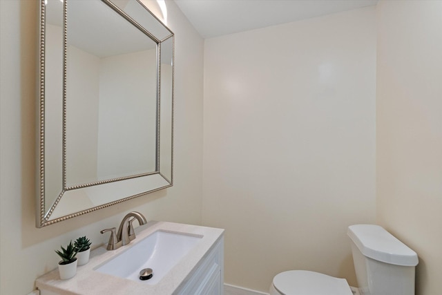 bathroom with toilet and vanity