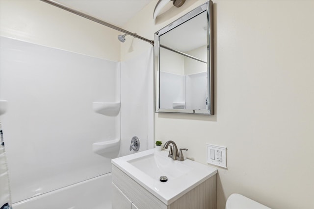 full bathroom featuring vanity, bathing tub / shower combination, and toilet