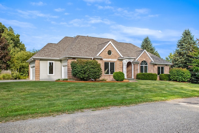 ranch-style home with a front yard and a garage