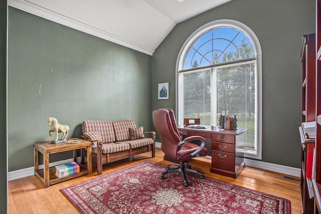 office area featuring lofted ceiling, baseboards, visible vents, and light wood finished floors