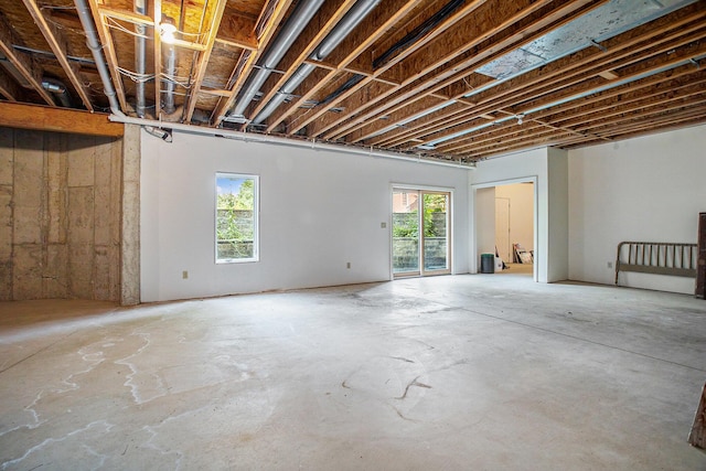 interior space featuring a healthy amount of sunlight and unfinished concrete floors