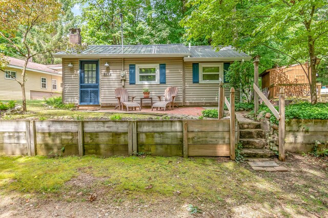 rear view of property featuring a patio