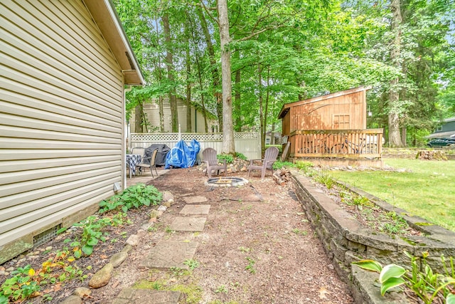 view of yard featuring a fire pit and fence