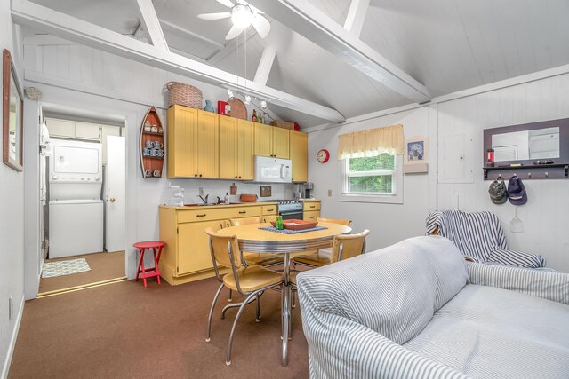 kitchen with stacked washing maching and dryer, vaulted ceiling with beams, range, and dark carpet