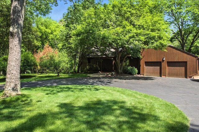 6710 Curtis Rd, Plymouth, MI 48170 - view of front of home featuring a front yard and a garage