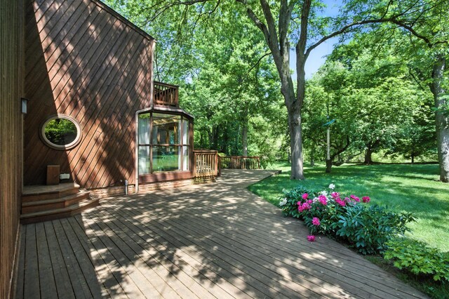 6710 Curtis Rd, Plymouth, MI 48170 - deck featuring a lawn and view of wooded area