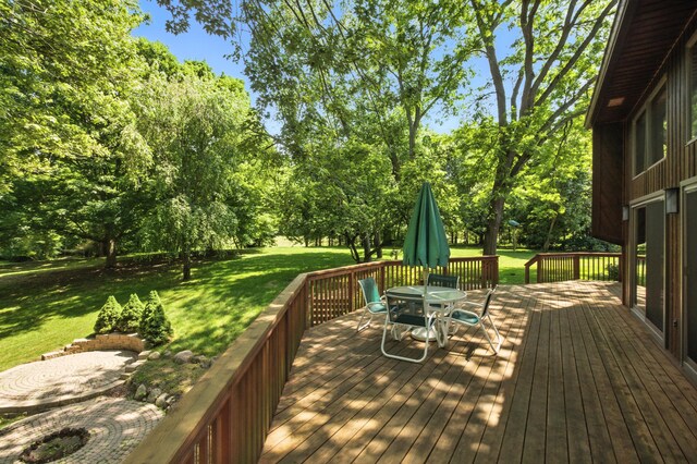 6710 Curtis Rd, Plymouth, MI 48170 - wooden terrace featuring a yard, outdoor dining space, and view of scattered trees