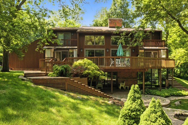 6710 Curtis Rd, Plymouth, MI 48170 - rear view of property with stairway, a balcony, a chimney, a wooden deck, and a yard
