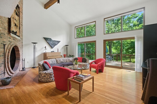 6710 Curtis Rd, Plymouth, MI 48170 - living area with high vaulted ceiling, wood finished floors, beam ceiling, and a brick fireplace