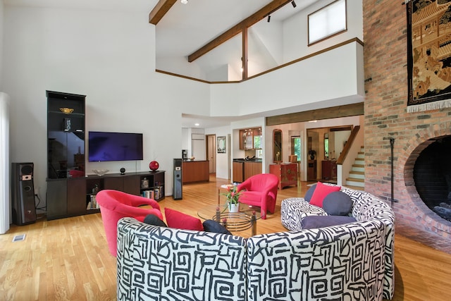 6710 Curtis Rd, Plymouth, MI 48170 - living area featuring wood finished floors, high vaulted ceiling, beam ceiling, and a fireplace