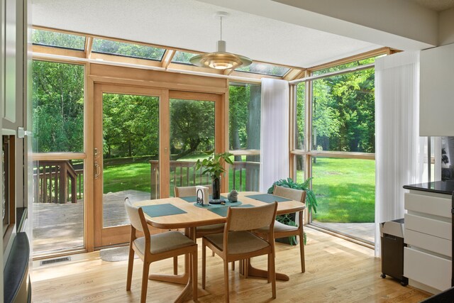 6710 Curtis Rd, Plymouth, MI 48170 - sunroom / solarium with a deck, wood finished floors, and plenty of natural light